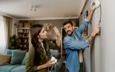Un couple discute de la réglementation caméra de surveillance particulier pendant l'installation d'un appareil.