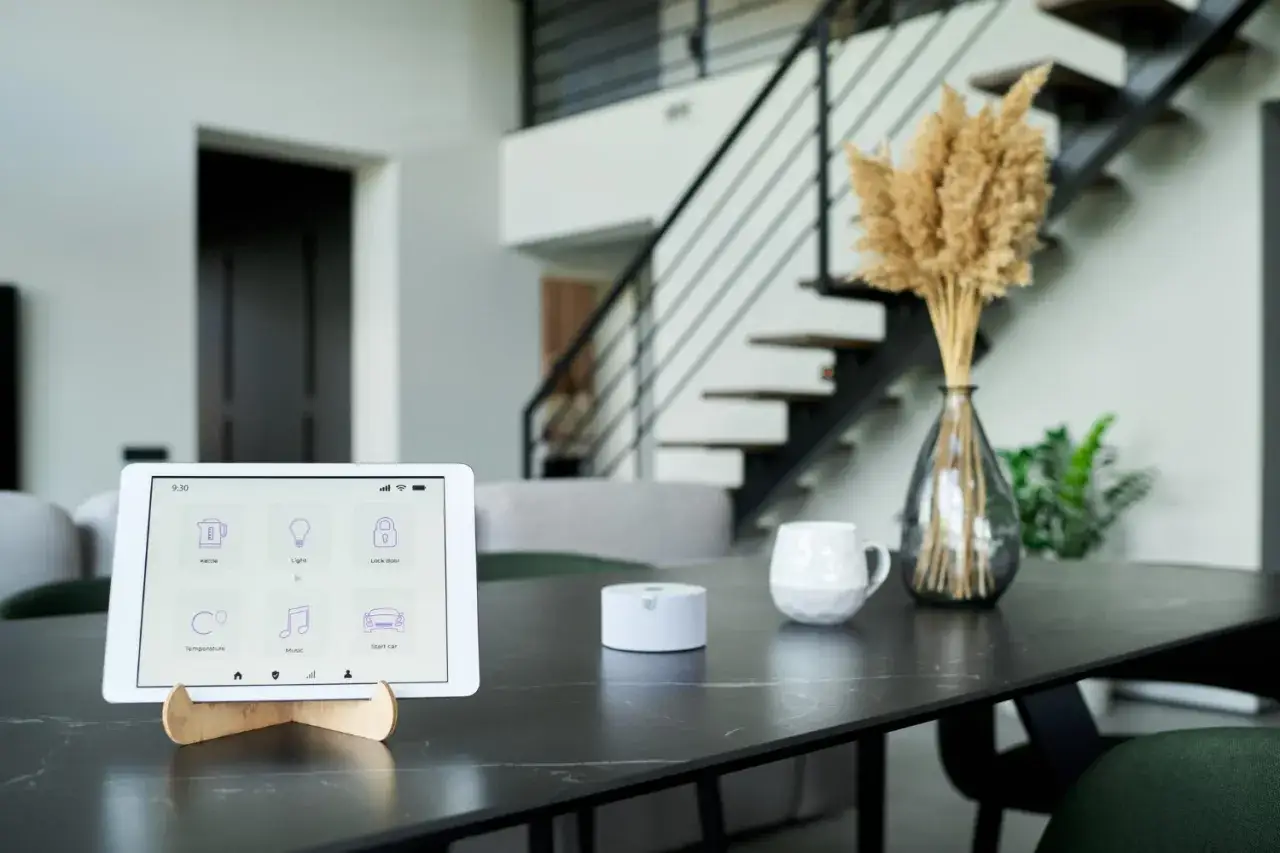 Tablette affichant l'interface d'un smartthings hub pour contrôler la maison : bouilloire, lumière, porte, température, musique et voiture.