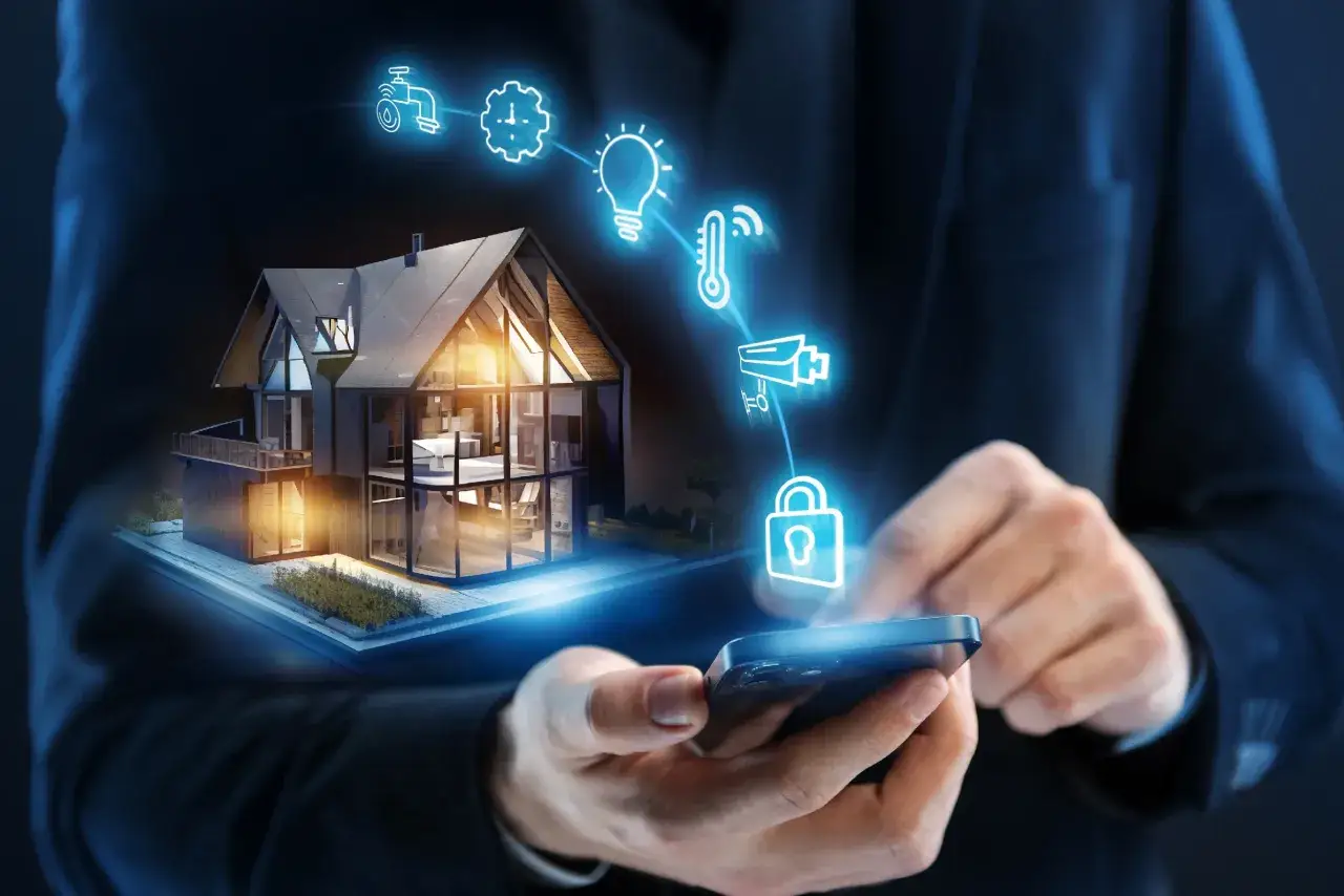Maison moderne contr&ocirc;l&eacute;e par smartphone, avec ic&ocirc;nes lumineuses repr&eacute;sentant les eve systems : eau, horloge, ampoule, thermom&egrave;tre, cam&eacute;ra, cadenas.